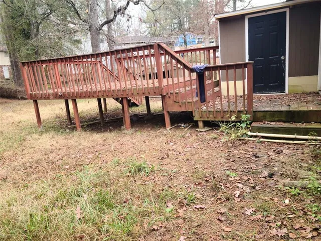 a view of a house with wooden fence