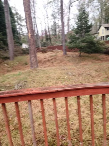 a view of yard with wooden fence