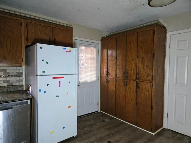 a white refrigerator freezer sitting inside of a kitchen