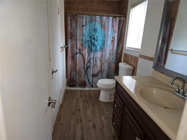 a bathroom with a sink toilet a tub and shower