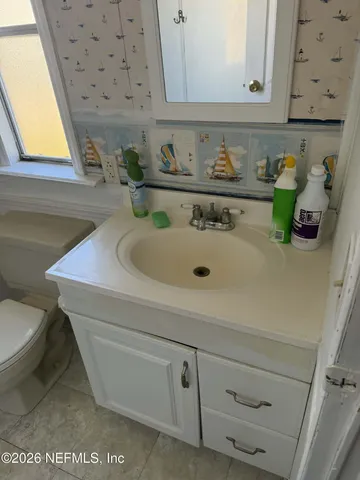 a bathroom with a sink a toilet and a bathtub