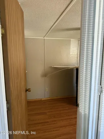 a bathroom with a granite countertop toilet sink and mirror