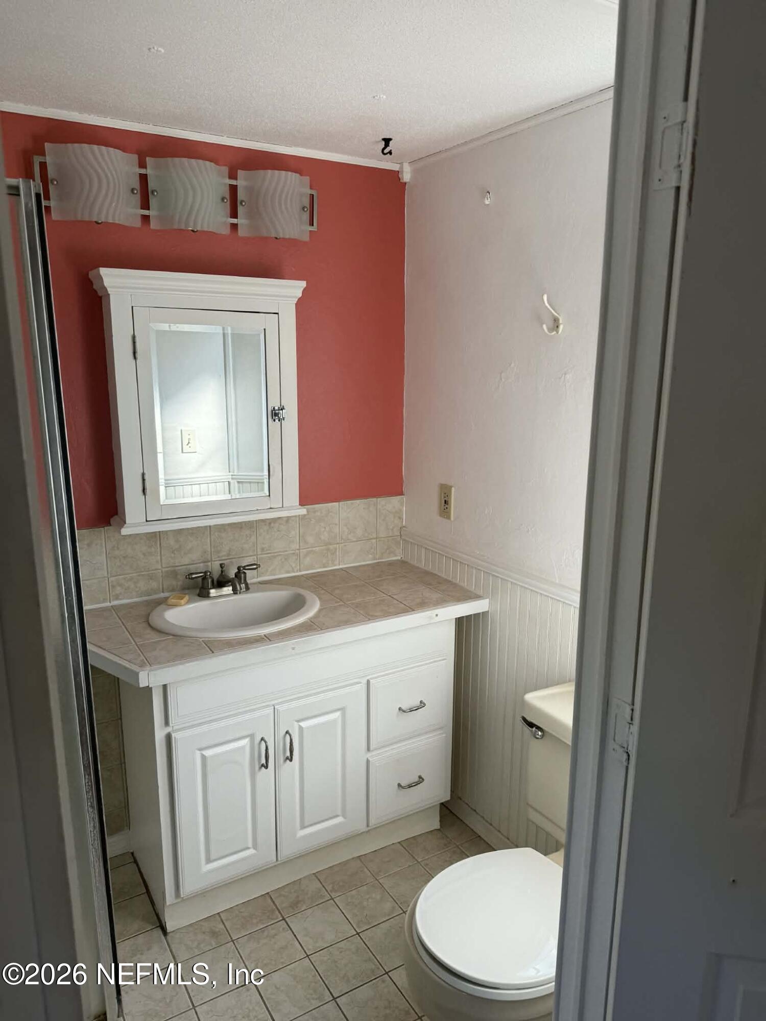 133 Sportsman Road Satsuma, FL 32189 - Photo 18 of 45 a bathroom with a granite countertop toilet sink and mirror