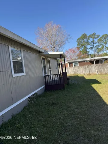 a view of a kitchen with a sink and a refrigerator