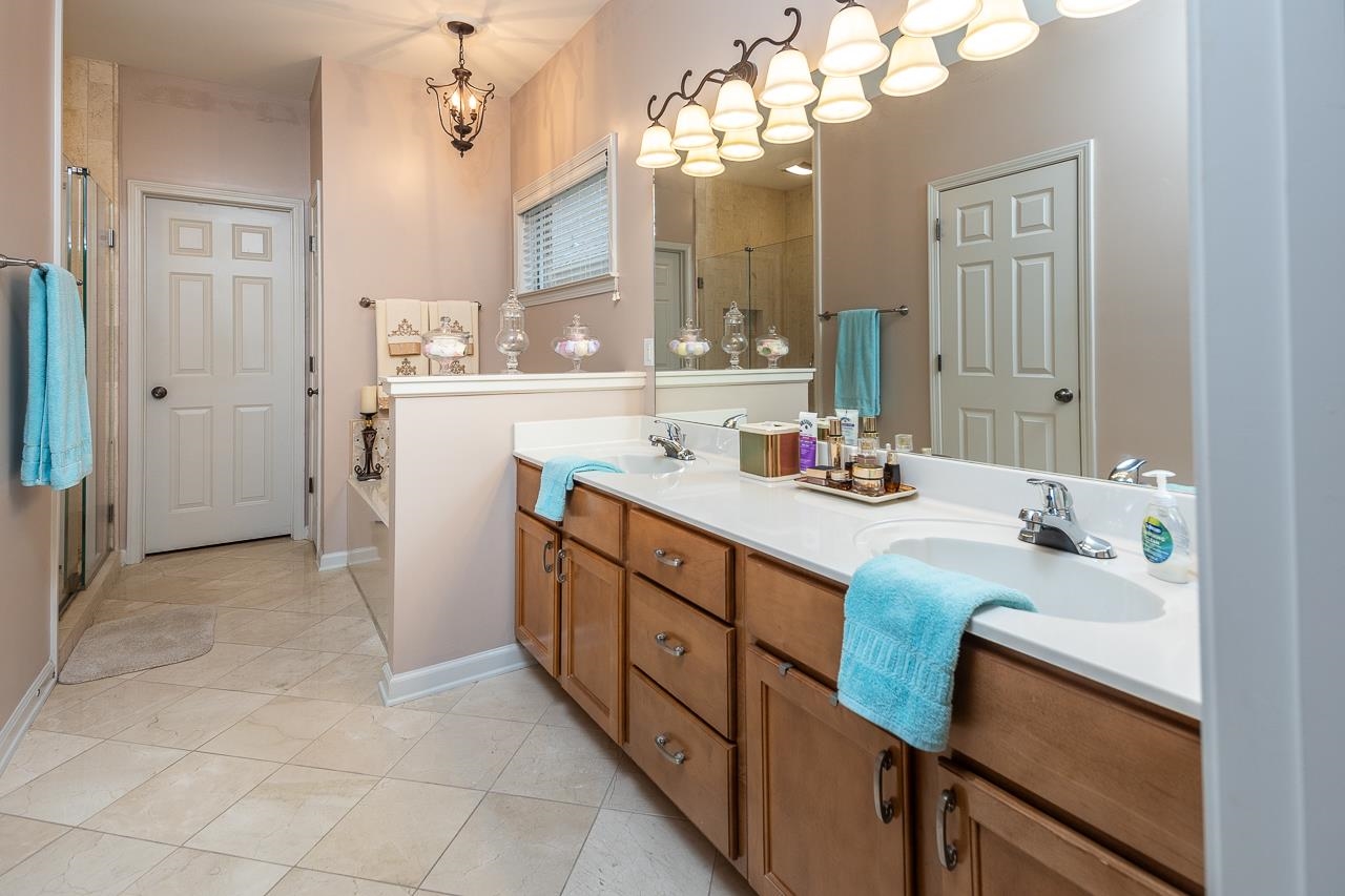 6031 Grayce Drive Bartlett, TN 38134 - Photo 13 of 31 a bathroom with a sink a vanity and a mirror