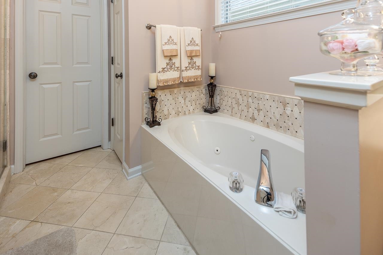 6031 Grayce Drive Bartlett, TN 38134 - Photo 15 of 31 a bathroom with a tub sink and mirror