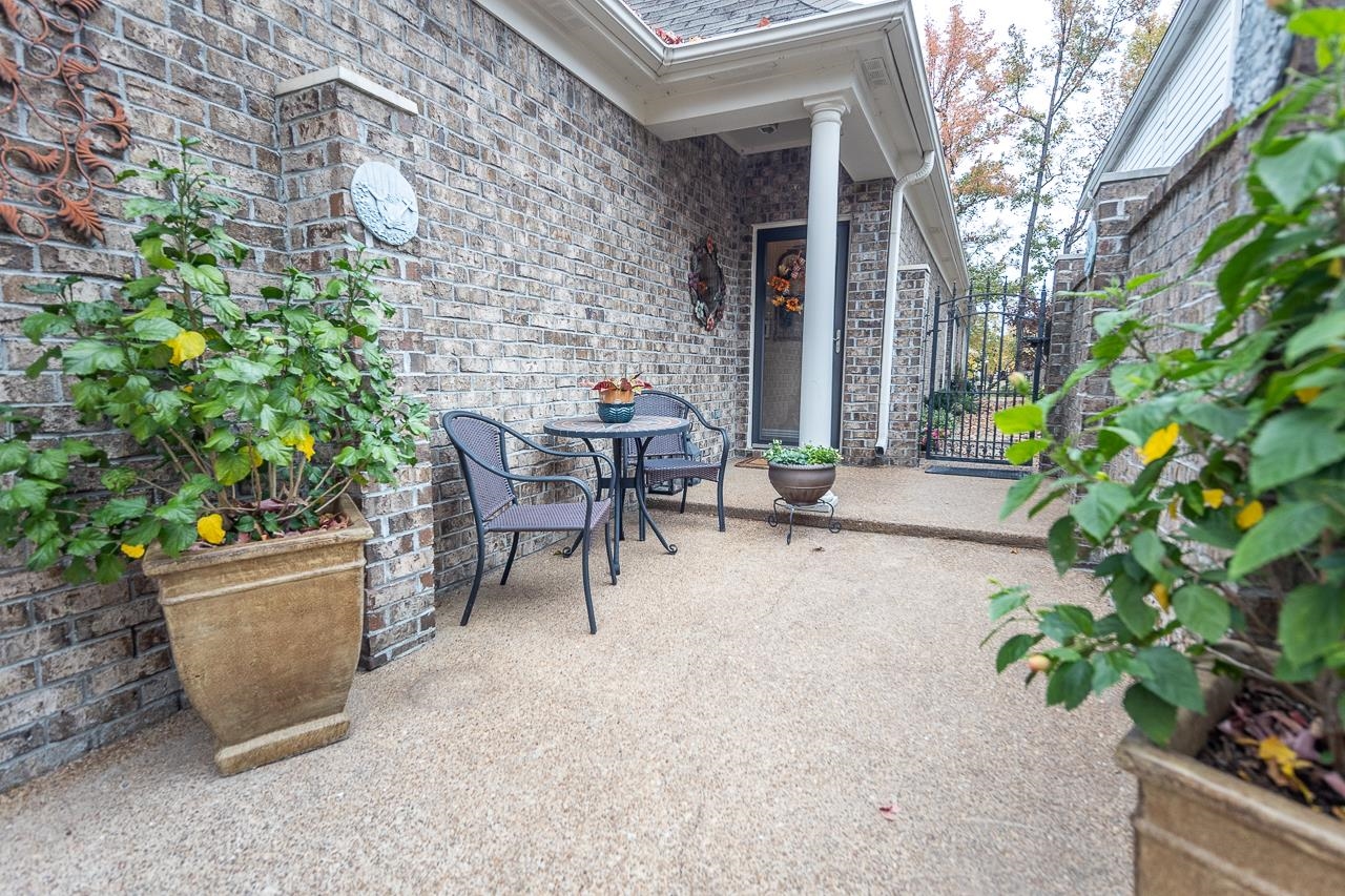 6031 Grayce Drive Bartlett, TN 38134 - Photo 21 of 31 a patio with table and chairs and potted plants