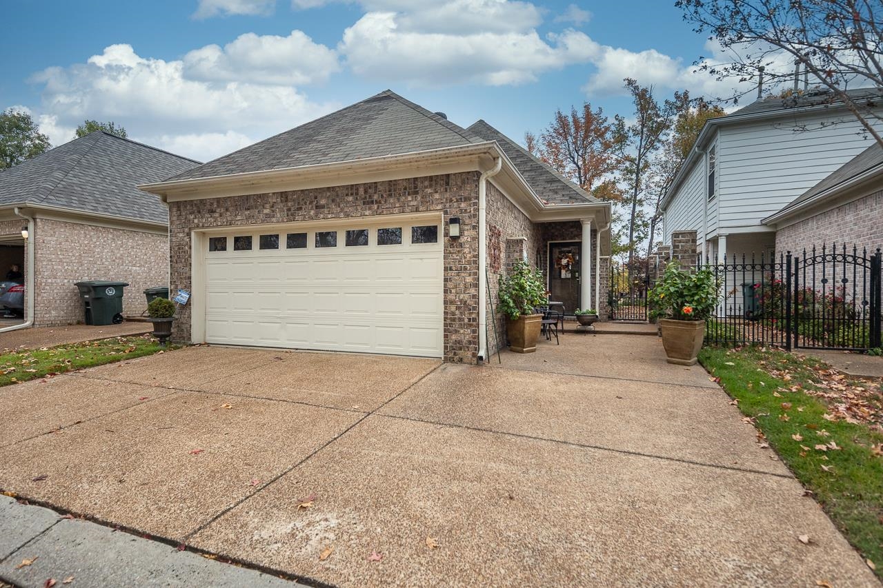 6031 Grayce Drive Bartlett, TN 38134 - Photo 22 of 31 a front view of a house with a yard and garage