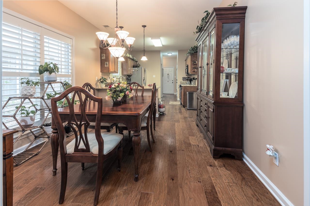 6031 Grayce Drive Bartlett, TN 38134 - Photo 7 of 31 a view of a dining room with furniture and wooden floor