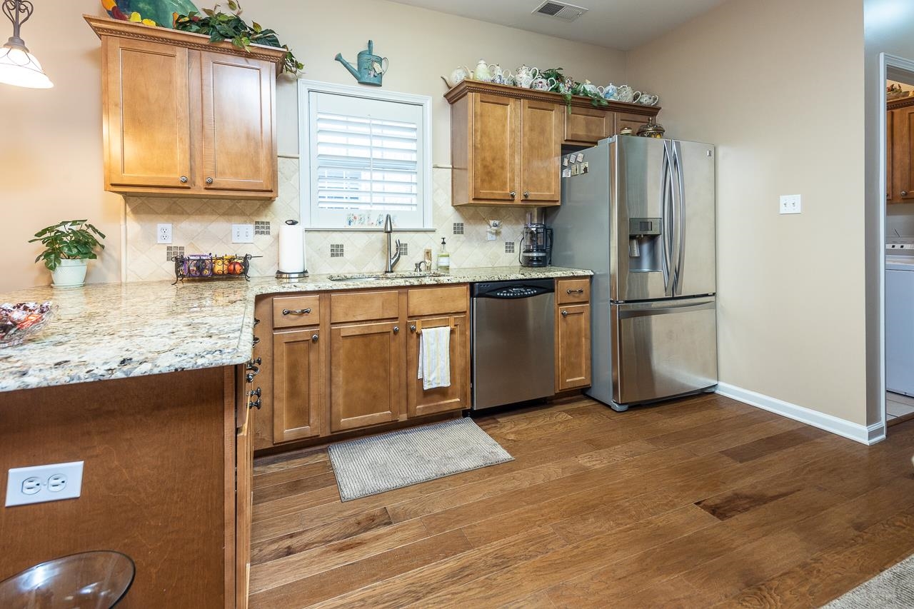6031 Grayce Drive Bartlett, TN 38134 - Photo 9 of 31 a kitchen with stainless steel appliances granite countertop a refrigerator sink and cabinets