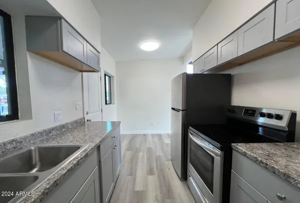 a kitchen that has a sink and a stove