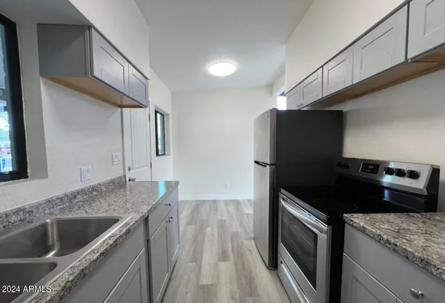 a kitchen that has a sink and a stove