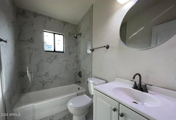 a bathroom with a sink toilet and bathtub