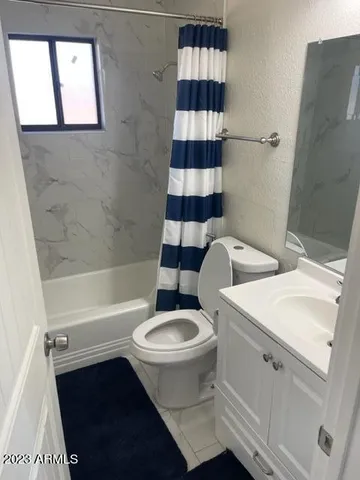 a white toilet sitting next to a bathroom sink and tub