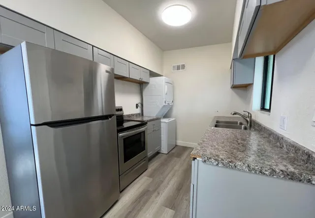 a kitchen with a refrigerator and a sink