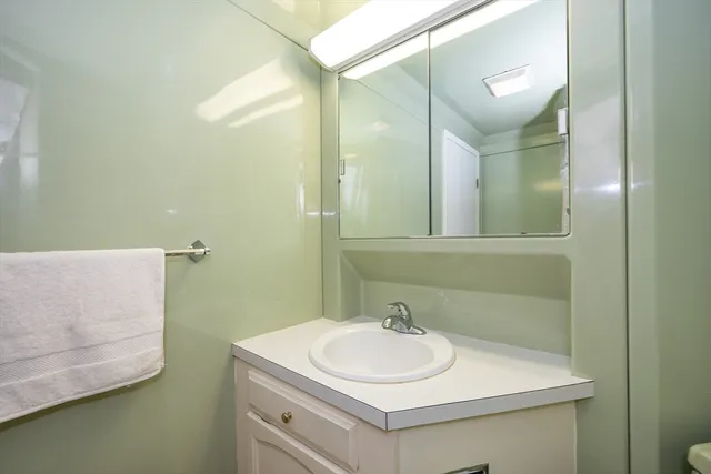 a view of a swimming pool with a lawn chairs under an umbrella