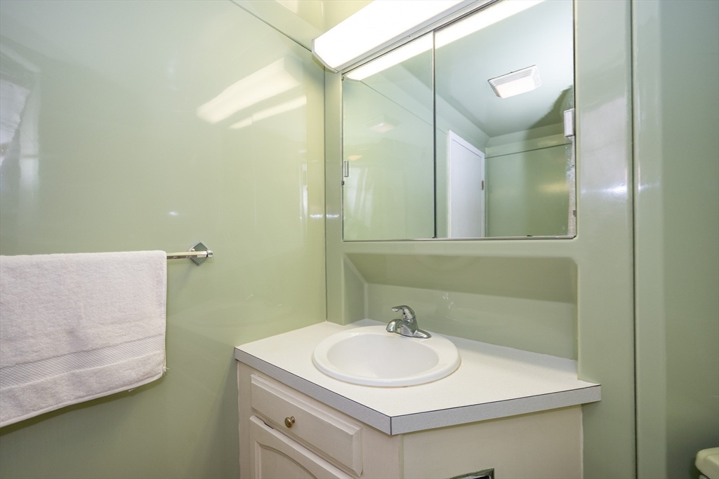 73 Broad Reach, Unit M21C Weymouth, MA 02191 - Photo 19 of 39 a bathroom with a sink and a mirror