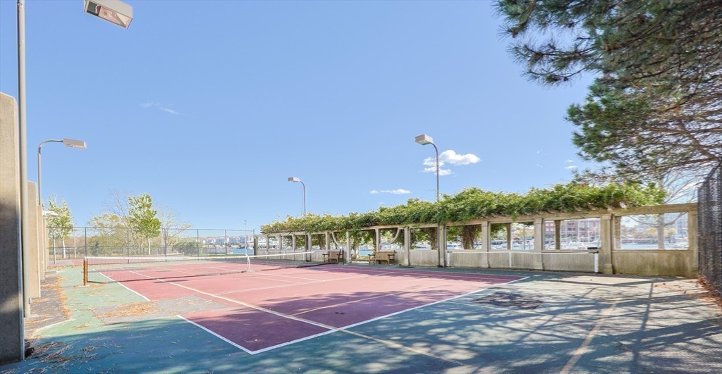73 Broad Reach, Unit M21C Weymouth, MA 02191 - Photo 23 of 39 a view of a tennis ground with large trees