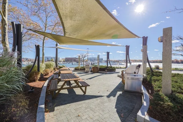 a living room with a black white checkered floor with couches chair and a coffee table