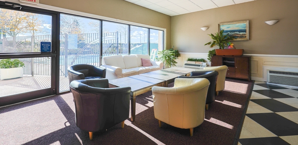 73 Broad Reach, Unit M21C Weymouth, MA 02191 - Photo 31 of 39 a dining room with furniture and a floor to ceiling window
