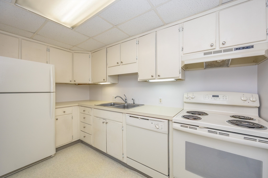 73 Broad Reach, Unit M21C Weymouth, MA 02191 - Photo 5 of 39 a kitchen with cabinets appliances a sink and a counter
