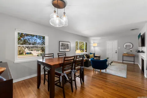 a kitchen with a table chairs refrigerator and microwave