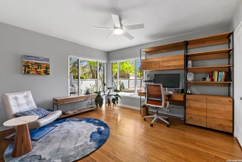 a view of a patio with table and chairs under an umbrella
