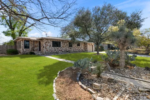 a view of a house with a backyard porch and sitting area