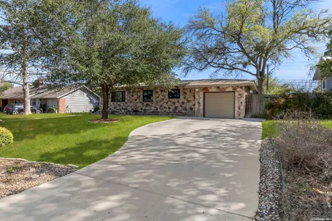 a view of house with yard and outdoor seating