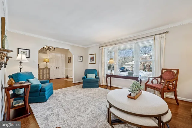 a view of a dining room with furniture a chandelier and wooden floor