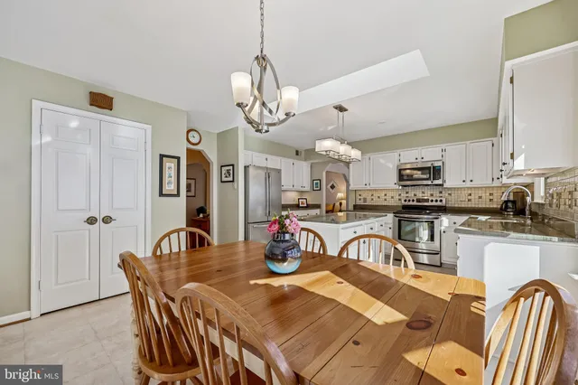 a living room with furniture a piano and a flat screen tv