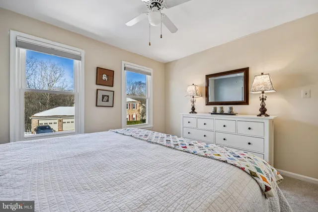 a view of a white house with a road