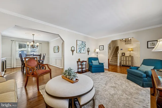 a view of a dining room with furniture a chandelier and wooden floor
