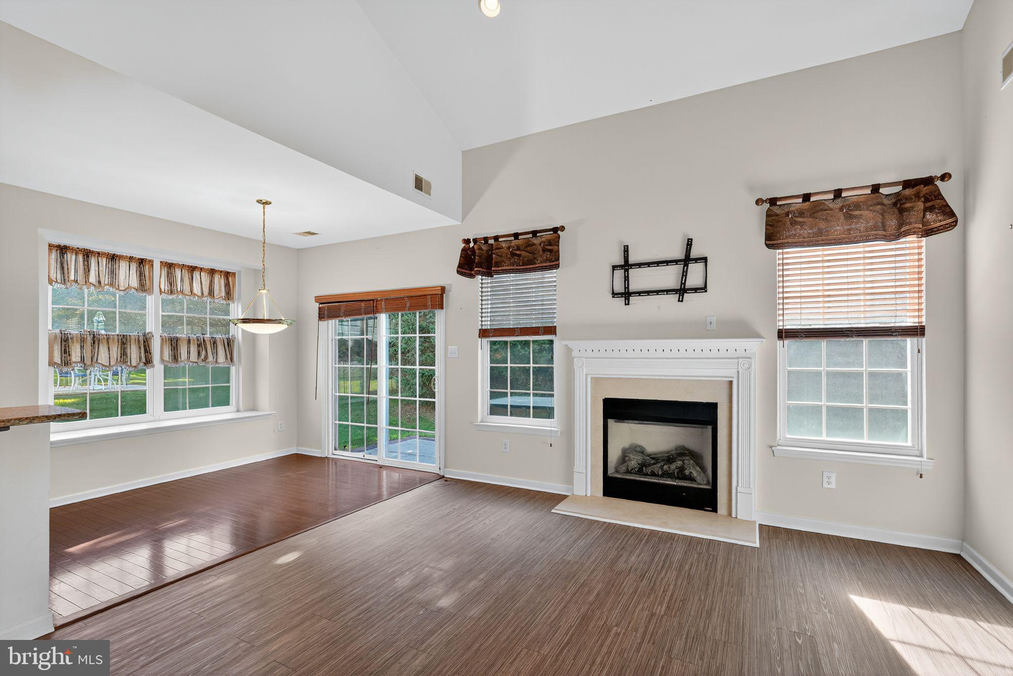 137 Stoyer Road Coatesville, PA 19320 - Photo 12 of 21 a view of livingroom with furniture a fireplace and windows