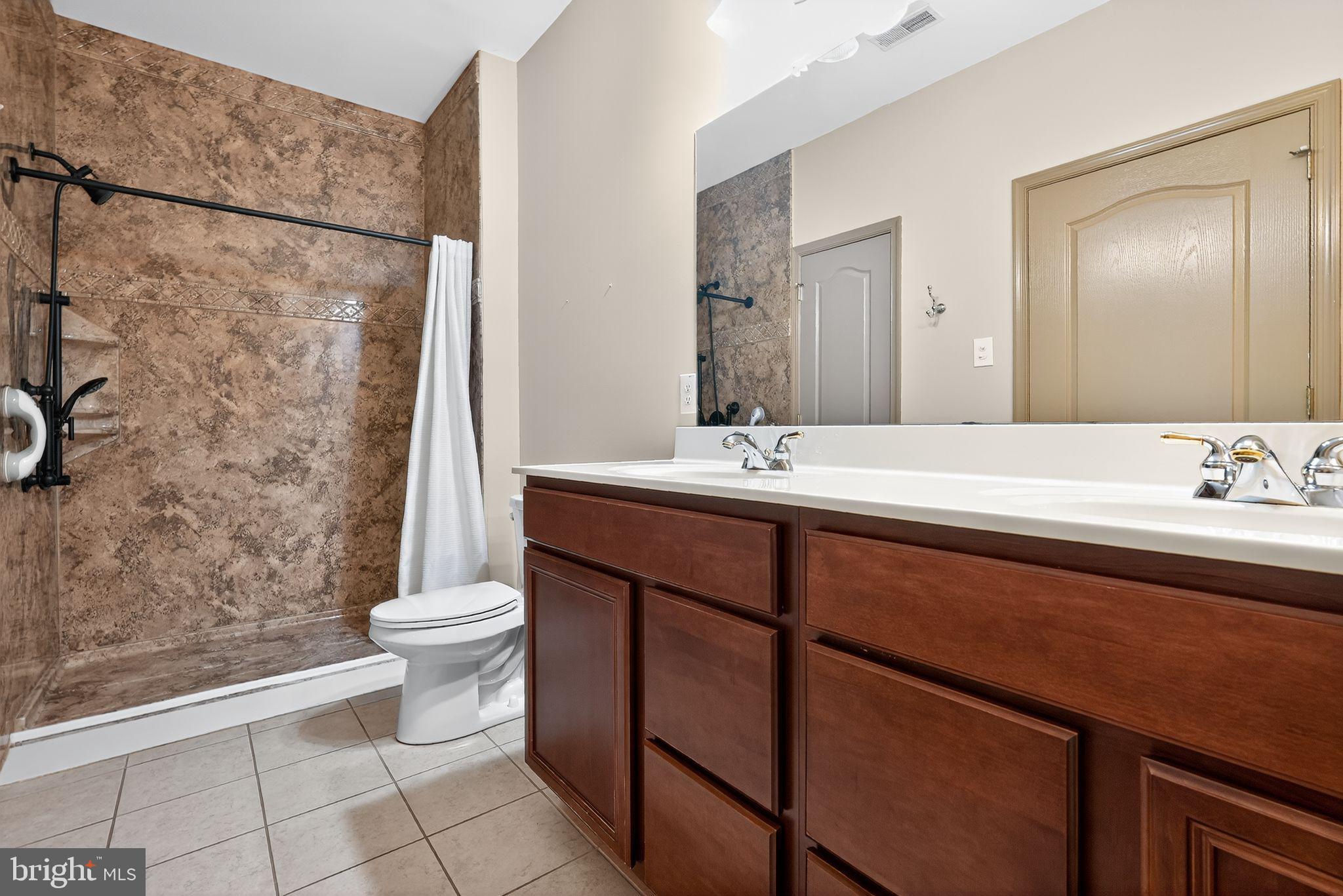 137 Stoyer Road Coatesville, PA 19320 - Photo 15 of 21 a bathroom with a double vanity sink toilet and shower