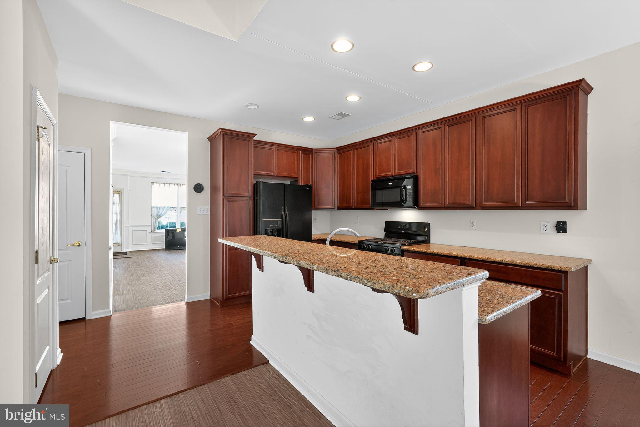 137 Stoyer Road Coatesville, PA 19320 - Photo 5 of 21 a kitchen with stainless steel appliances granite countertop a refrigerator a sink dishwasher and a stove with wooden floor