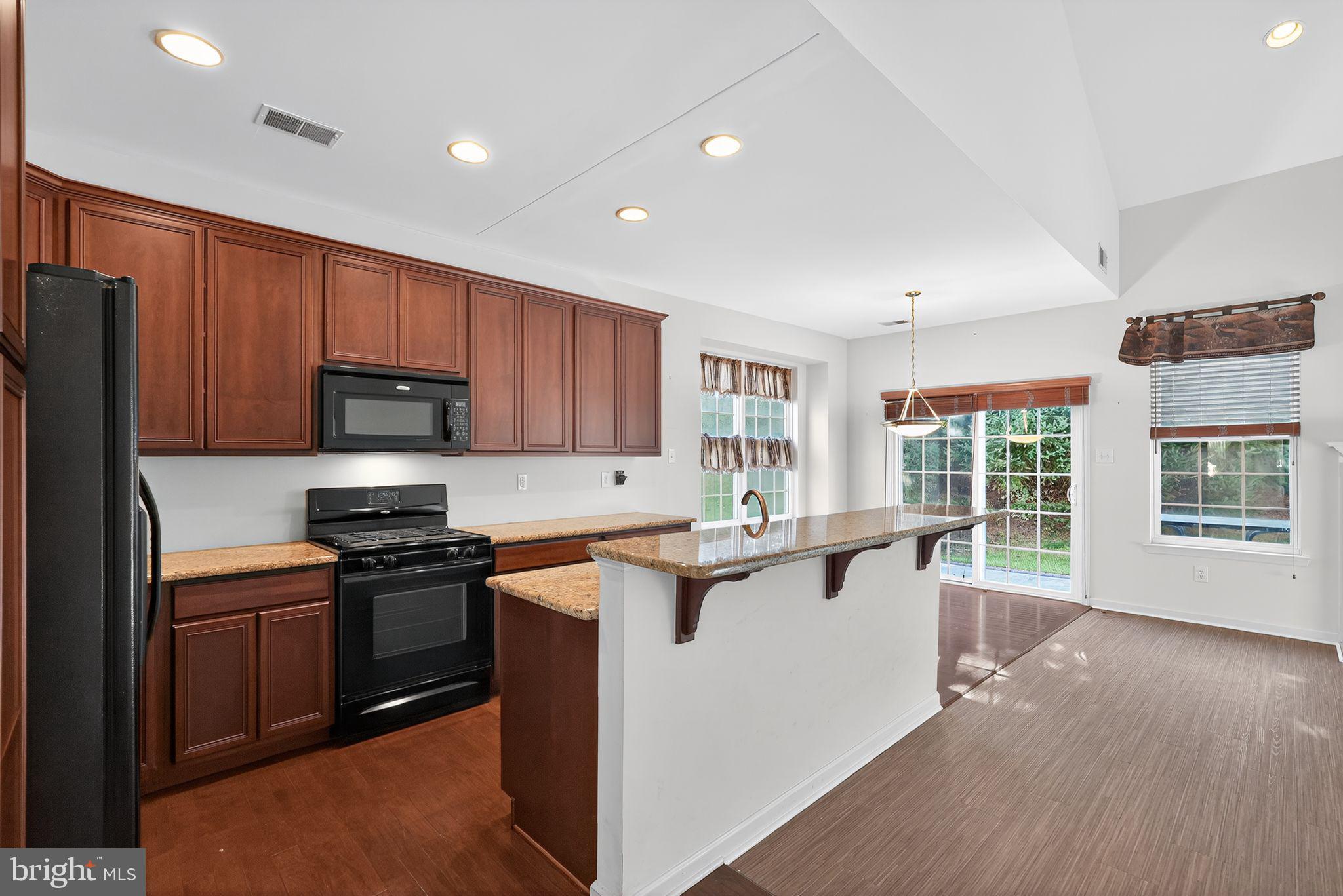 137 Stoyer Road Coatesville, PA 19320 - Photo 6 of 21 a kitchen with stainless steel appliances a stove top oven a sink a refrigerator a window and grass