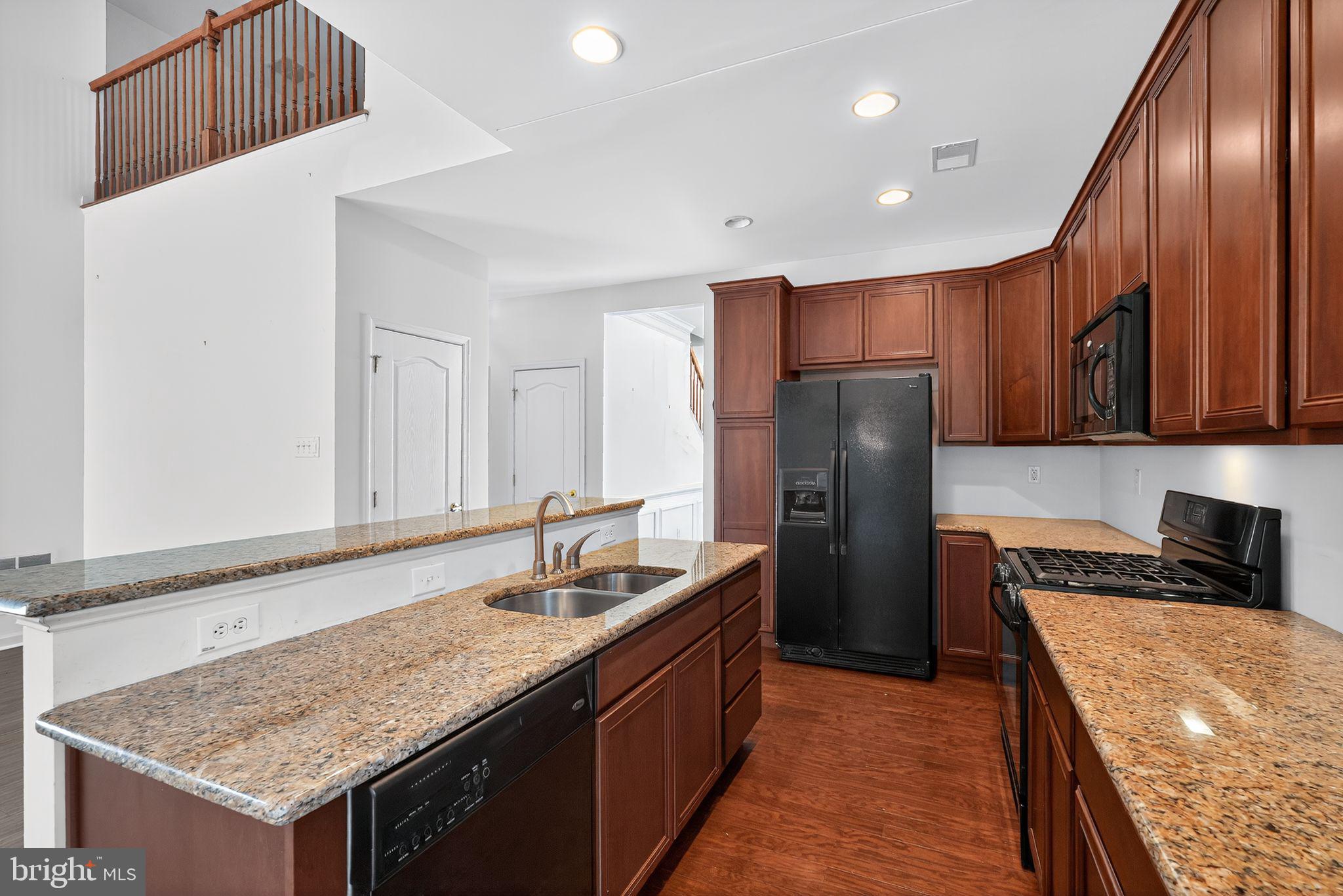137 Stoyer Road Coatesville, PA 19320 - Photo 7 of 21 a kitchen with stainless steel appliances granite countertop a sink stove and refrigerator