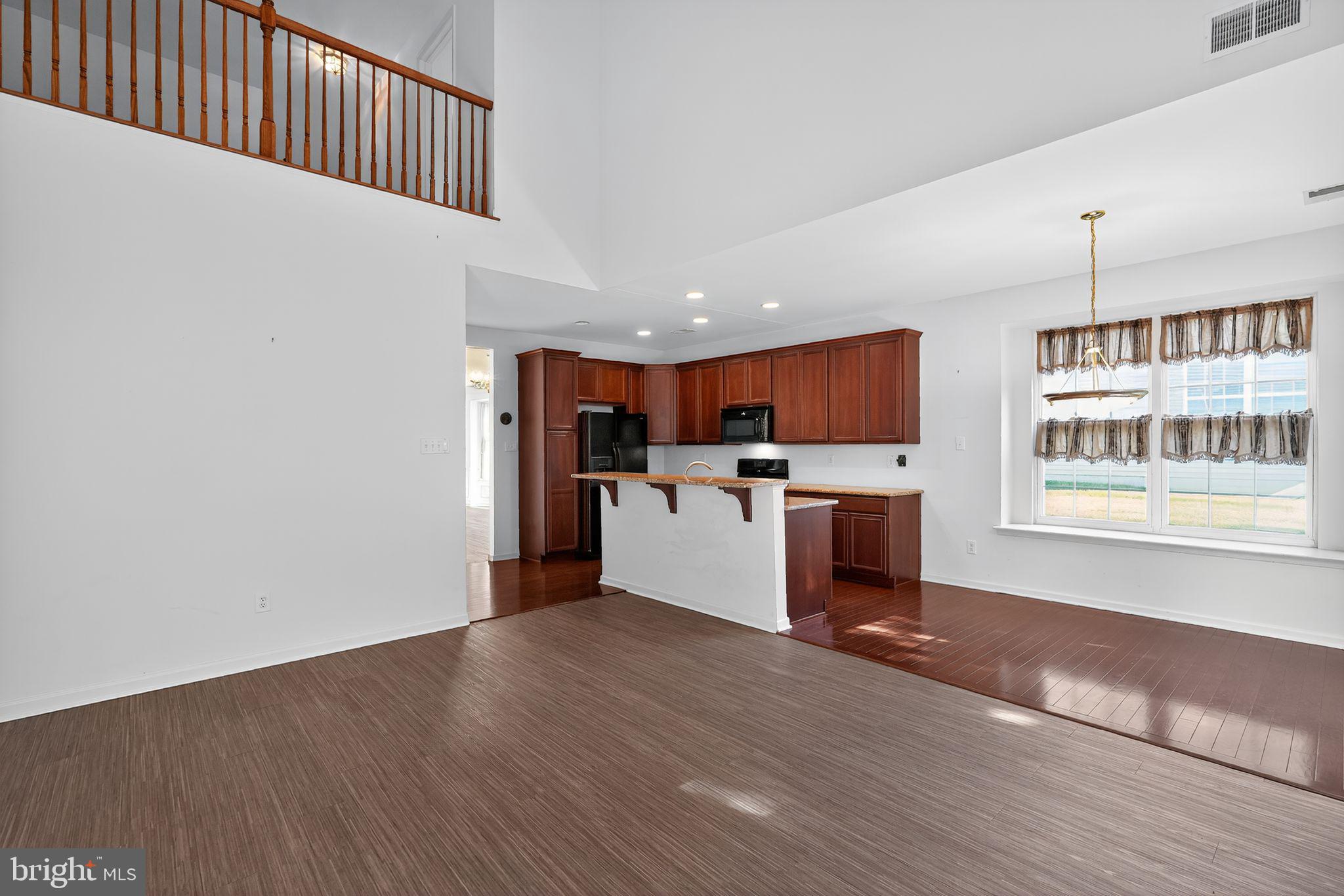 137 Stoyer Road Coatesville, PA 19320 - Photo 9 of 21 a kitchen with stainless steel appliances kitchen island wooden floors and white cabinets