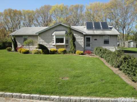 21 Madeline Road Ridge, NY 11961 - Photo 1 of 1 a front view of house with yard and green space
