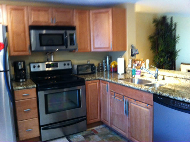 1068 Jeffery Street Boca Raton, FL 33487 - Photo 5 of 13 a kitchen with stainless steel appliances granite countertop a stove microwave and sink