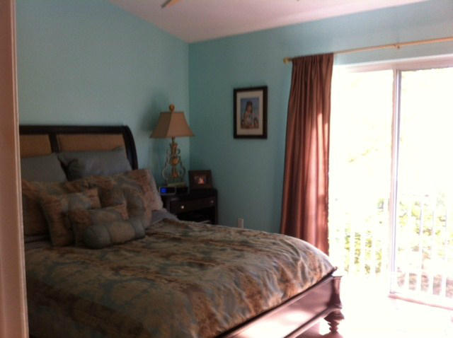 1068 Jeffery Street Boca Raton, FL 33487 - Photo 7 of 13 a large bed sitting in a bedroom next to a window