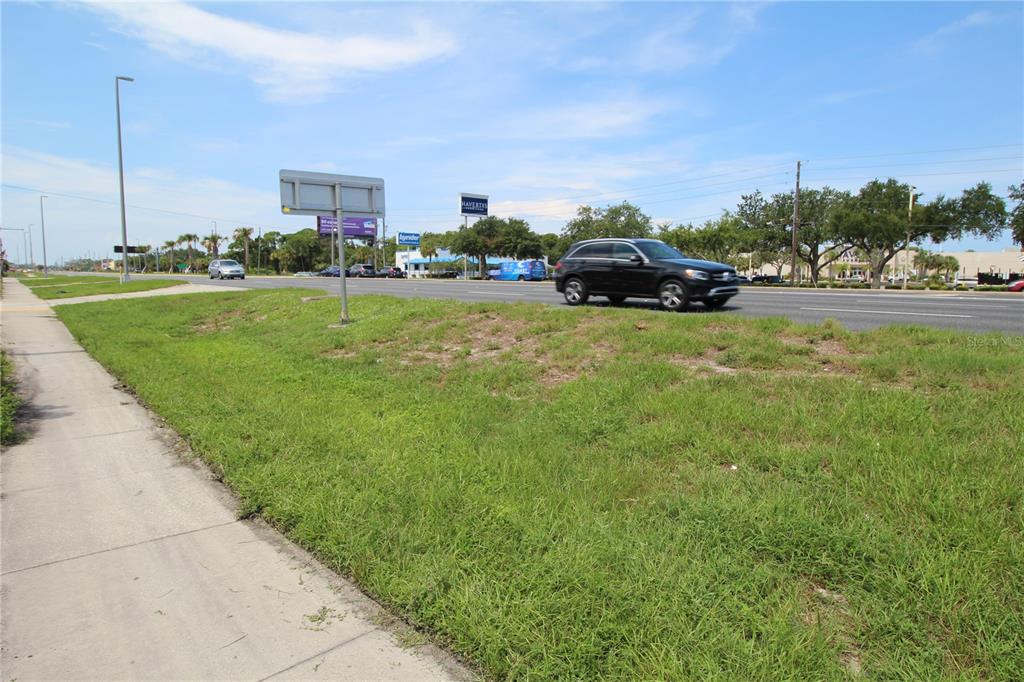 8900 U.S. Highway 19 Port Richey, FL 34668 - Photo 26 of 27 a front view of a house with a garden and car parked