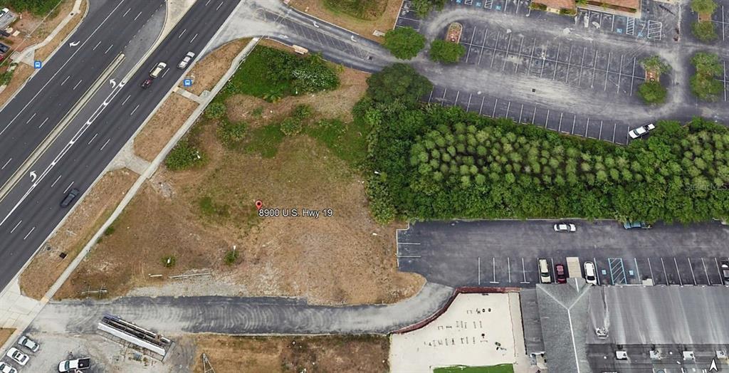 8900 U.S. Highway 19 Port Richey, FL 34668 - Photo 4 of 27 an aerial view of a house with a yard and plants
