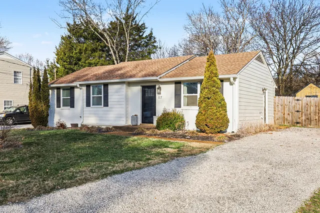 a view of a wooden bench next to a yard