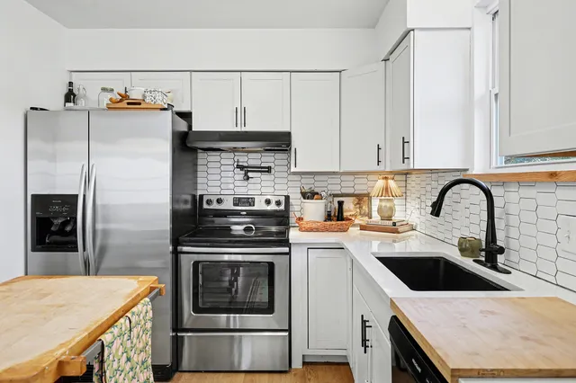 a kitchen with a sink a stove and refrigerator