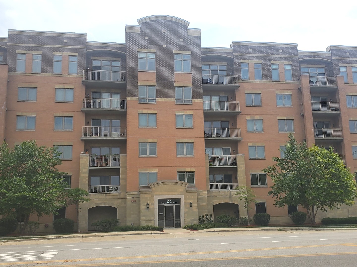 77 North Wolf Road, Unit 310 Northlake, IL 60164 - Photo 1 of 13 a tall building sitting on the side of a street