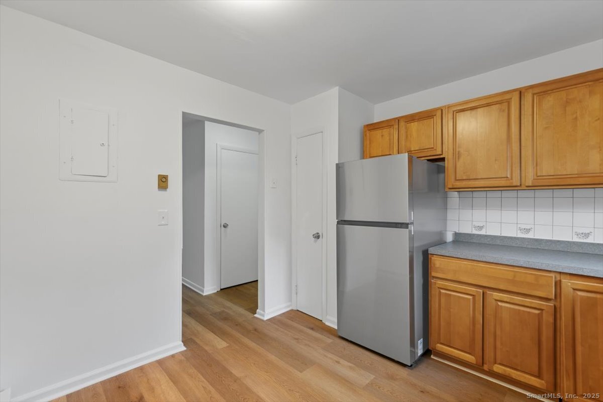 2998 Madison Avenue, Unit C Bridgeport, CT 06606 - Photo 11 of 24 a kitchen with a refrigerator sink and cabinets