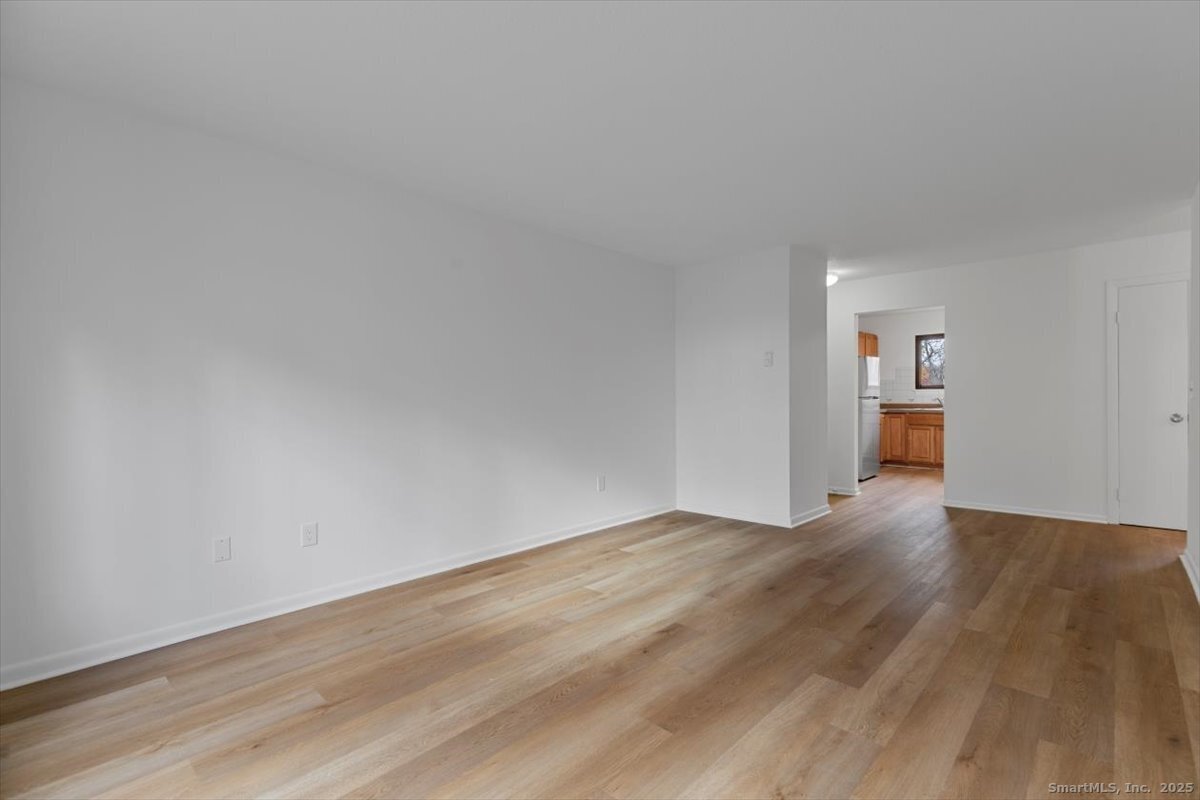 2998 Madison Avenue, Unit C Bridgeport, CT 06606 - Photo 8 of 24 a view of empty room with wooden floor and cabinet