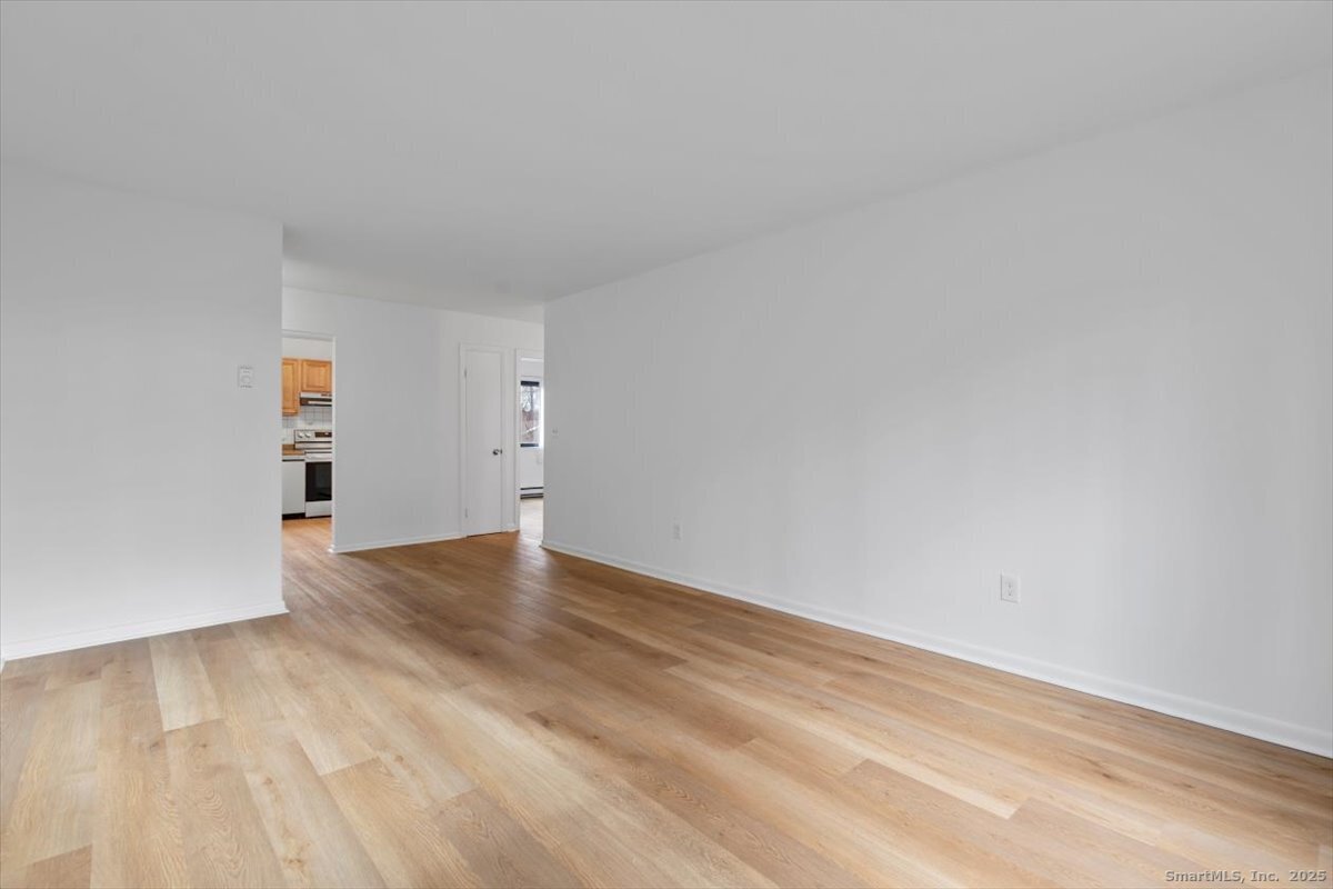 2998 Madison Avenue, Unit C Bridgeport, CT 06606 - Photo 9 of 24 a view of empty room with wooden floor